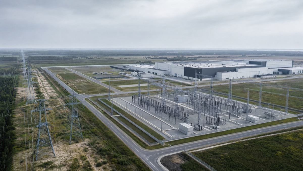 Aerial view of a substation where a transmission corridor meets an industrial campus.